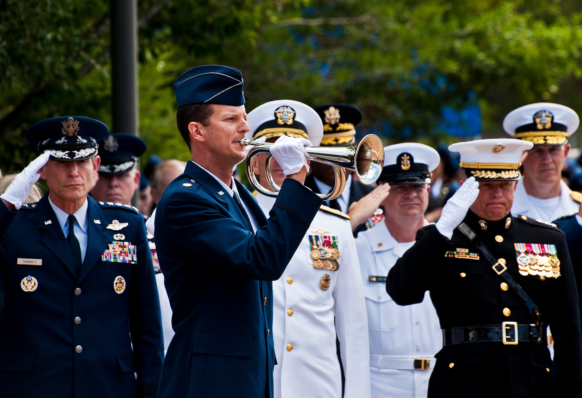 An Air Force bugler plays Taps at the conclusion of the 43rd Annual Explosive Ordnance Disposal Memorial Ceremony May 5, 2012, at Eglin Air Force Base, Fla.  Air Force Chief of Staff Gen. Norton Schwartz (left) was the guest speaker for the event that honored 18 EOD technicians, five of which were Airmen.  With the new names added, there are now 287 names inscribed on the memorial wall.  (U.S. Air Force photo/Samuel King Jr.)