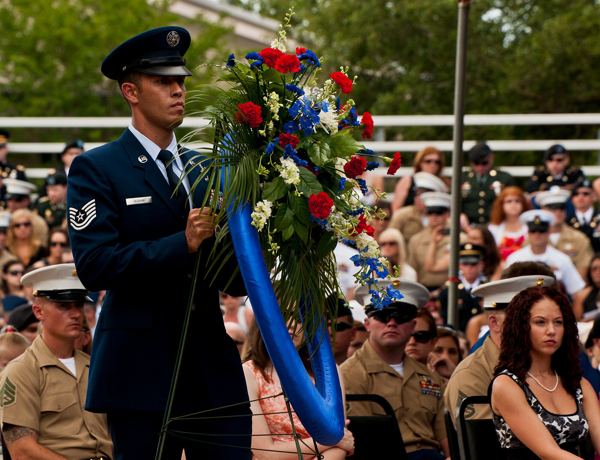 Tech. Sgt. Benjamin McGraw, 366th Training Squadron Det. 3, carries in a wreath to be placed in front of the Air Force portion of the explosive ordnance disposal memorial wall during the 43rd Annual EOD Memorial Ceremony May 5, 2012, at Eglin Air Force Base, Fla.  Air Force Chief of Staff Gen. Norton Schwartz was the guest speaker for the event that honored 18 EOD technicians, five of which were Airmen.  With the new names added, there are now 287 names inscribed on the memorial wall.  (U.S. Air Force photo/Samuel King Jr.)