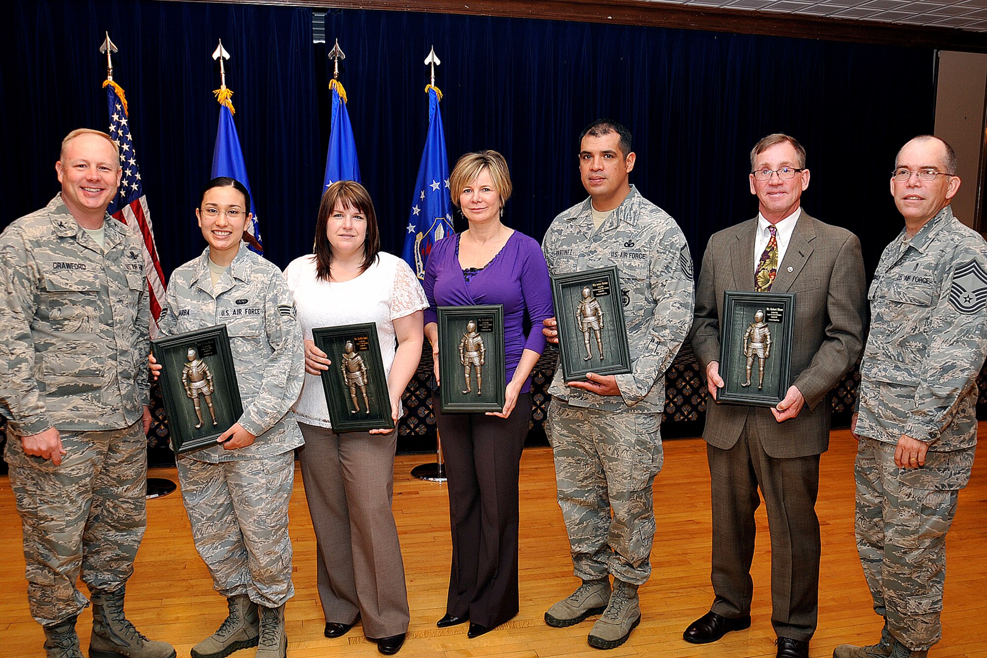 PETERSON AIR FORCE BASE, Colo. – The 21st Space Wing held its quarterly awards breakfast May 1 at The Club. Col. Chris Crawford (left), 21st SW commander, and Chief Master Sgt. Kent McCormack (right), 21st Dental Squadron, presented awards to winners (left to right) Senior Airman Crystal Barba, 76th Space Control Squadron; Kellie Smith, 21st Medical Support Squadron; Renata Ott, 21st Contracting Squadron; Master Sgt. Antonio Martinez, 721st Security Forces Squadron; and Robert Dixon, 21st Civil Engineer Squadron. Other winners not pictured are Capt. Heather Ortiz, 21st Medical Group, and Tech. Sgt. Gerald Morey, 821st Air Base Group. (U.S. Air Force photo/Dennis Howk)