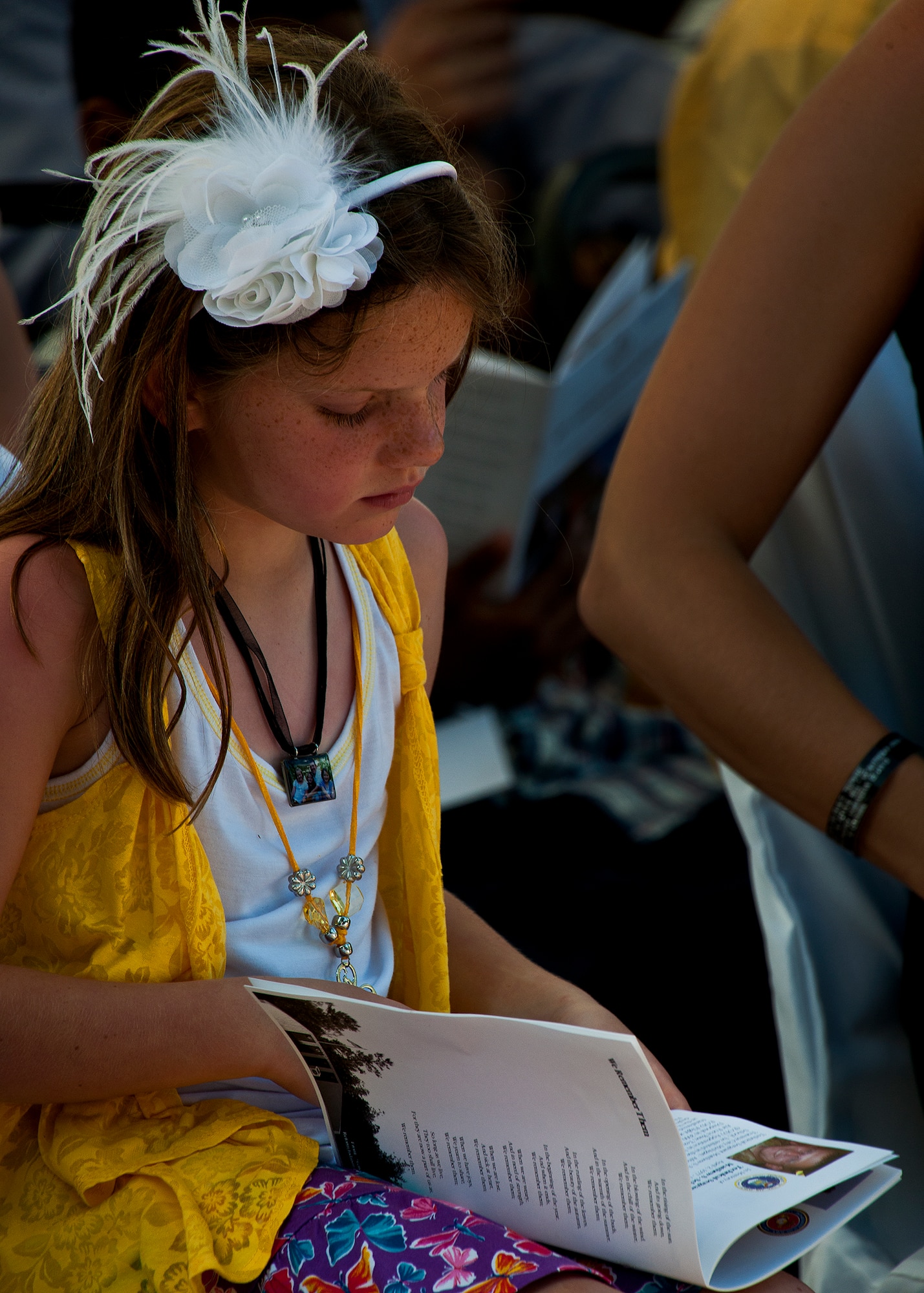 Aliza reads the bio of her father, Tech. Sgt. Matthew Schwartz, a fallen explosive ordnance disposal Airman being honored at the 43rd Annual Explosive Ordnance Disposal Memorial Ceremony May 5, 2012, at Eglin Air Force Base, Fla.  Air Force Chief of Staff Gen. Norton Schwartz was the guest speaker for the event that honored the technical sergeant and 17 EOD technicians.  With the new names added, there are now 287 names inscribed on the memorial wall.  (U.S. Air Force photo/Samuel King Jr.)