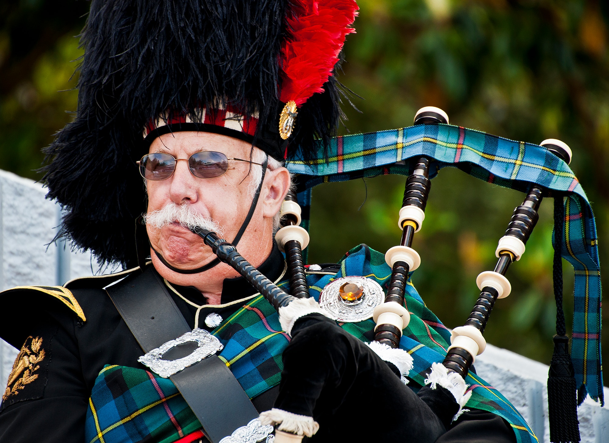 A bagpiper performs for a crowd of hundreds prior to the 43rd Annual Explosive Ordnance Disposal Memorial Ceremony May 5, 2012, at Eglin Air Force Base, Fla.  Air Force Chief of Staff Gen. Norton Schwartz was the guest speaker for the event that honored 18 EOD technicians, five of which were Airmen.  With the new names added, there are now 287 names inscribed on the memorial wall.  (U.S. Air Force photo/Samuel King Jr.)