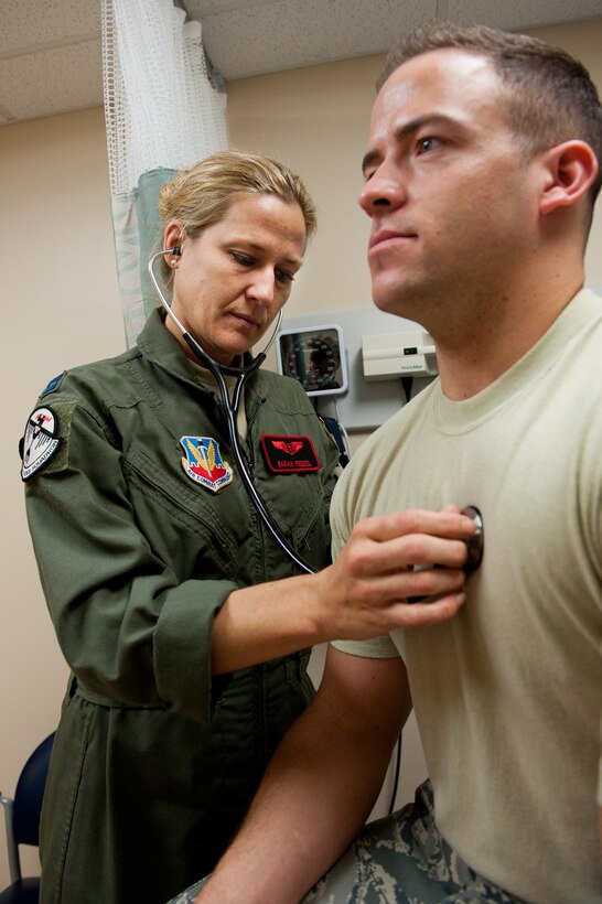 Capt. Sarah Freidel, 34th Bomb Squadron flight surgeon, listens to the heart of Staff Sgt. Jacob Appleby, 28th Medical Operations Squadron ambulance services technician, during a physical exam in the flight medicine clinic on Ellsworth Air Force Base, S.D., May 2, 2012. (U.S. Air Force photo by Airman 1st Class Kate Thornton/Released)