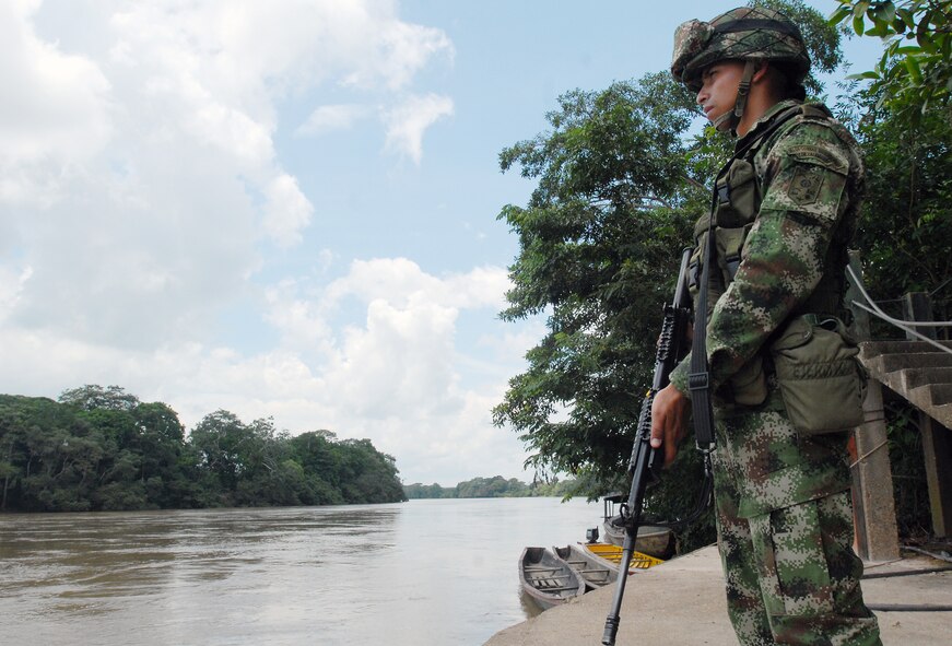 120428-A-WP252-002– A Colombian soldier keeps an eye on his area while providing security along the river in La Macarena, Colombia. Members of the Colombian military provided security during the two-day Surgical Civic Action Program (SURGCAP) April 27-28 in the small town, located 170 miles south of Bogota. In an effort to assist its citizens living in the nation’s remote towns, the Colombian military organized this two-day SURGCAP April 27-28 with support from U.S. Army Civil Affairs Soldiers and “Patrulla Aerea Civil Colombiana” or PAC. (Department of Defense photo by Sgt. 1st Class Alex Licea, Special Operations Command South Public Affairs) (Contributing reporter for the U.S. Embassy in Bogota.)  