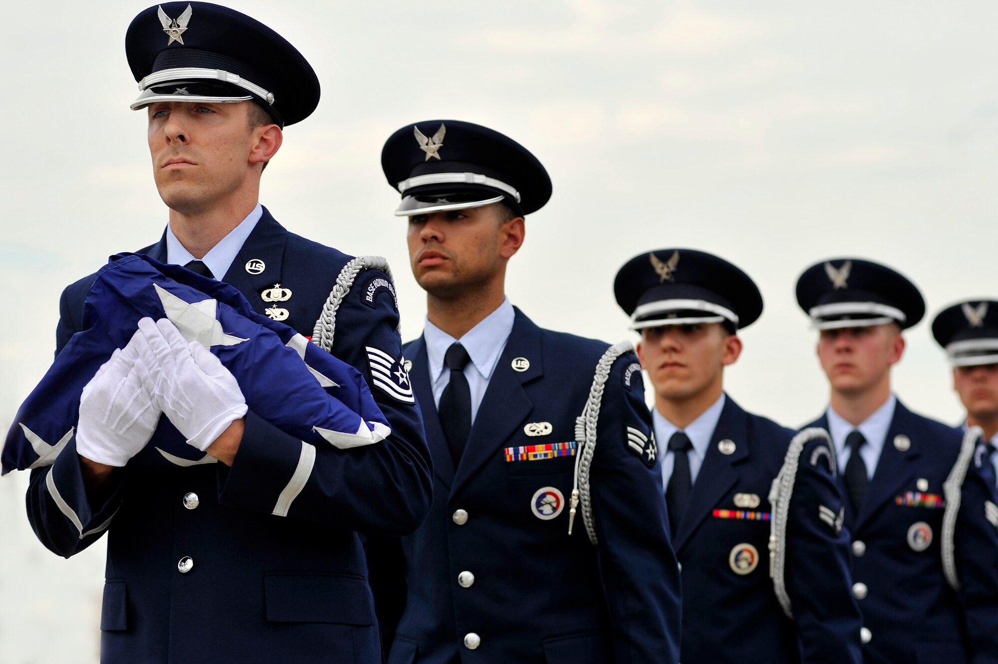 U.S. Air Force Airmen assigned to the Shaw Air Force Base Honor Guard, march in formation with a fold United States flag concluding a retreat ceremony, May 4, 2012, Shaw Air Force Base, S.C. Shaw's Honor Guard conducted the retreat ceremony at the end of the first day of Shaw's Air Expo. More than 80 Airmen assigned to the 20th Fighter Wing, including the 20th FW Commander Col. Clay Hall, stood in formation for the retreat. (U.S. Air Force photo by Senior Airman Kenny Holston/Released)


