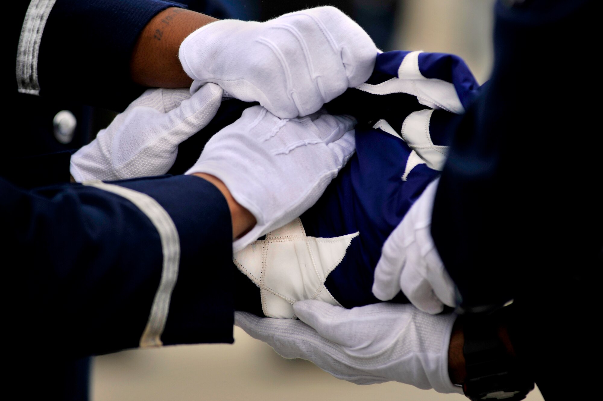 U.S. Air Force Airmen assigned to the Shaw Air Force Base Honor Guard, make the final adjustments to the United States flag after folding it during a retreat ceremony, May 4, 2012, Shaw Air Force Base S.C. Shaw's Honor Guard conducted the retreat ceremony at the end of the first day of Shaw's Air Expo. More than 80 Airmen assigned to the 20th Fighter Wing, including the 20th FW Commander Col. Clay Hall, stood in formation for the retreat. (U.S. Air Force photo by Senior Airman Kenny Holston/Released)



