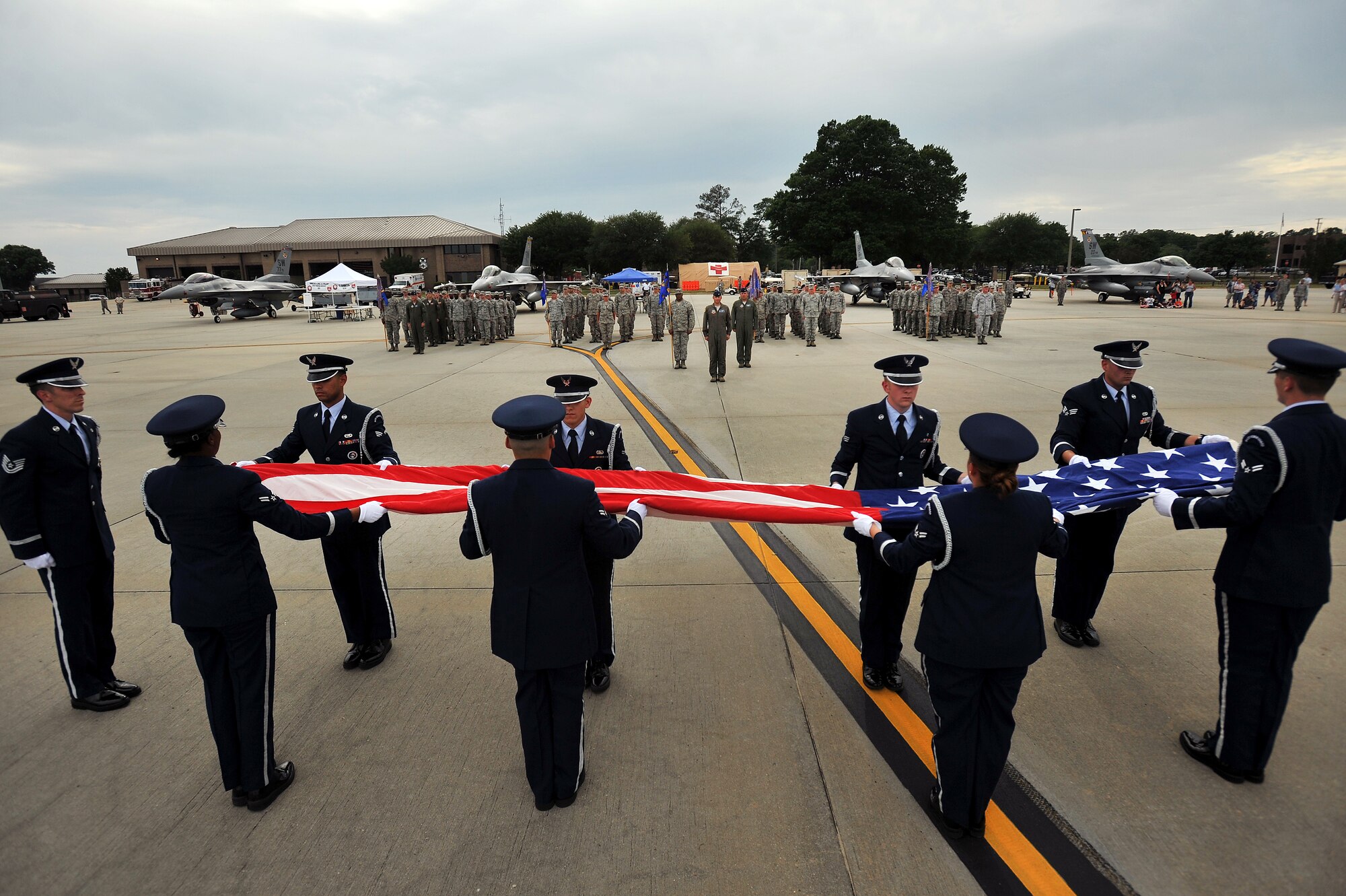 U.S. Air Force Airmen assigned to the Shaw Air Force Base Honor Guard, fold the United States flag during a retreat ceremony, May 4, 2012, Shaw Air Force Base, S.C. Shaw's Honor Guard conducted the retreat ceremony at the end of the first day of Shaw's Air Expo. More than 80 Airmen assigned to the 20th Fighter Wing, including the 20th FW Commander Col. Clay Hall, stood in formation for the retreat. (U.S. Air Force photo by Senior Airman Kenny Holston/Released)


