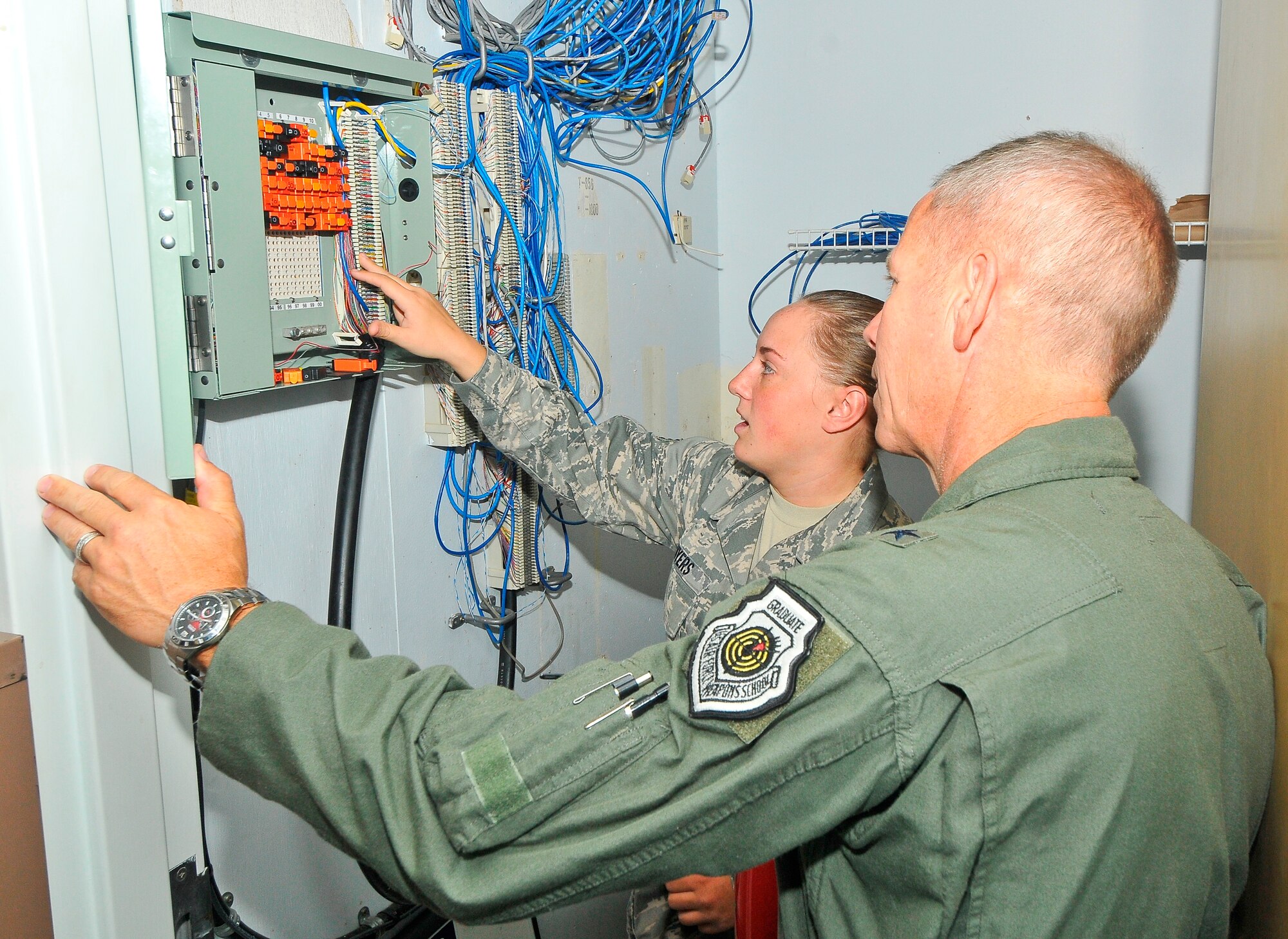 Senior Airman Shayna Myers, 325th Communication Squadron client systems technician, had the opportunity to show Brigadier Gen. John McMullen, 325th Fighter Wing commander, her daily responsibilities at the 325th Mission Support Group for the Airman’s Shadow program, May 4. (U.S.Air Force photo by Christopher Cokeing)

