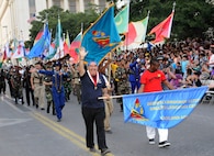 Students from the Defense Language Institute English Language Center at Joint Base San Antonio-Lackland march in the 2012 Fiesta Flambeau parade April 28. ( U.S. Air Force Photo by Don Lindsey)