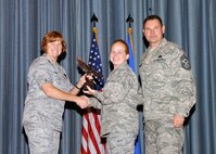 Col. Kimberly Toney (left), Air Force Recruiting Service vice commander, and Chief Master Sgt. William Cavenaugh (left), AFRS chief, present the Company Grade Officer of the Quarter Award to Capt. Erika Chute, Air Force Personnel Center. The first-quarter Joint Base San Antonio-Randolph award winners were recognized during an awards ceremony at the base theater May 4. (U.S. Air Force photo by Melissa Peterson)