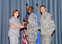 Col. Kimberly Toney (left), Air Force Recruiting Service vice commander, and Chief Master Sgt. William Cavenaugh (left), AFRS chief, present the Honor Guard NCO of the Quarter Award to Staff Sgt. Desmond Boyd, Air Force Personnel Center. The first-quarter Joint Base San Antonio-Randolph award winners were recognized during an awards ceremony at the base theater May 4. (U.S. Air Force photo by Melissa Peterson)