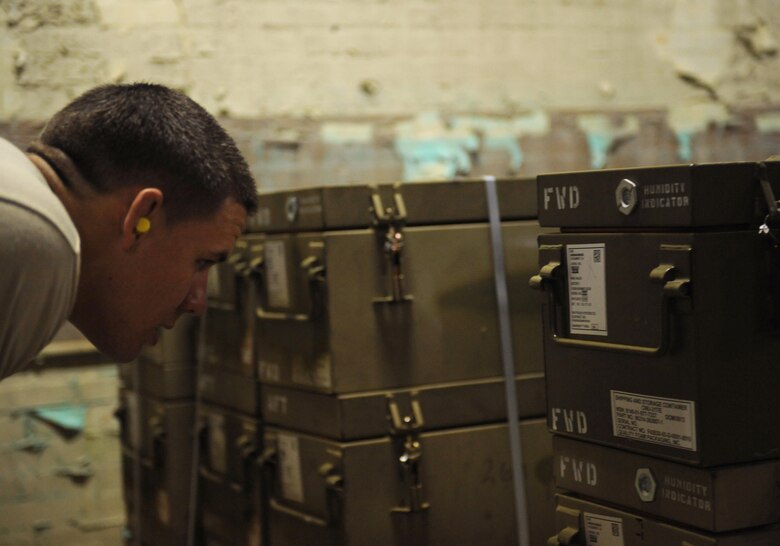 Senior Airman Erik Sands, 2nd Munitions Squadron storage and handling, checks the type of munitions before moving them on Barksdale Air Force Base, La., May 4. Sands checked the cases prior to moving the munitions to ensure the right parts were gathered for the Airmen building the bombs. The correct combination of parts dictate explosion times, impact points and blast radius. (U.S. Air Force photo/Airman 1st Class Benjamin Gonsier)
