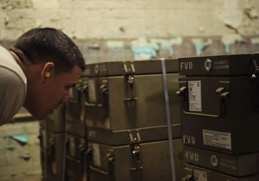 Senior Airman Erik Sands, 2nd Munitions Squadron storage and handling, checks the type of munitions before moving them on Barksdale Air Force Base, La., May 4. Sands checked the cases prior to moving the munitions to ensure the right parts were gathered for the Airmen building the bombs. The correct combination of parts dictate explosion times, impact points and blast radius. (U.S. Air Force photo/Airman 1st Class Benjamin Gonsier)