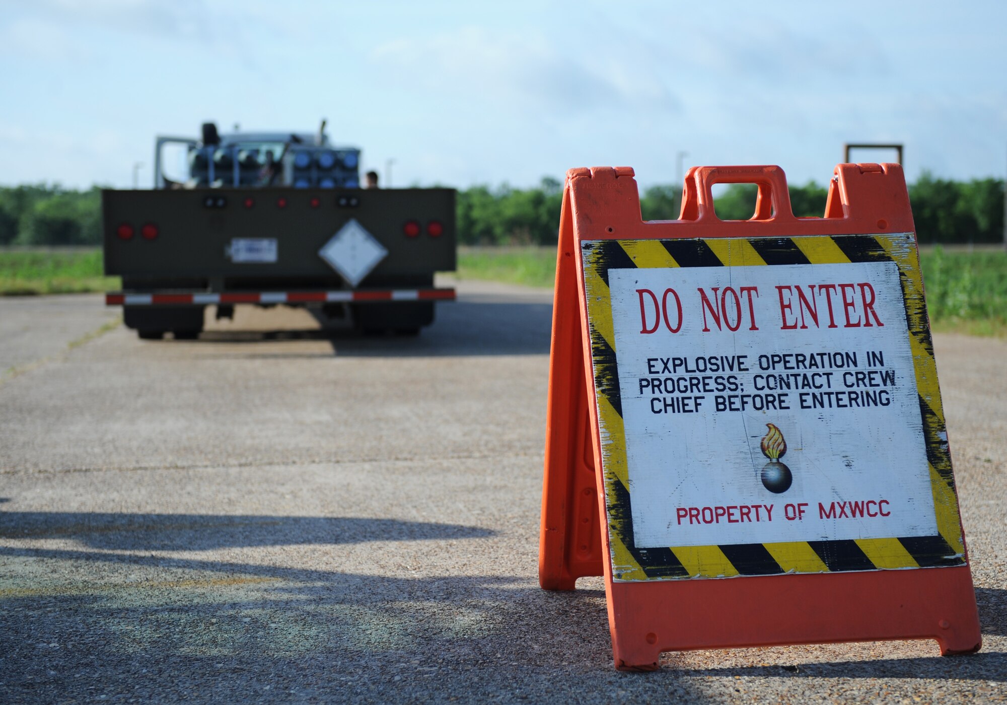 A sign sits in front of a vehicle loaded with munitions on Barksdale Air Force Base, La., May 4. As a safety precaution, a warning sign must be placed in front of the area where 2nd Munitions Squadron Airmen are working. The designated crew chief of the operation must have control of the area and prevent anyone without proper authorization from entering into the cordoned zone. (U.S. Air Force photo/Airman 1st Class Benjamin Gonsier)