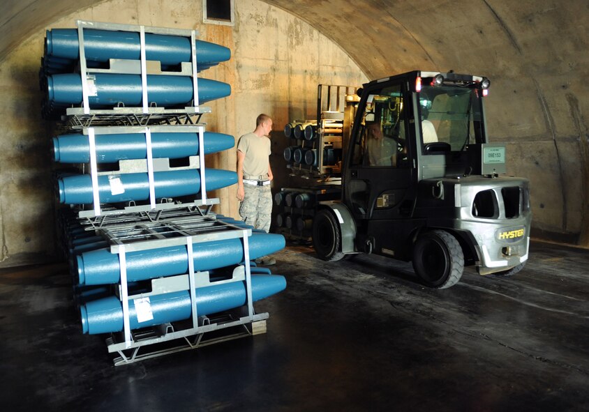 Airmen from the 2nd Munitions Squadron storage and handling unit load inert bombs onto a 6K forklift on Barksdale Air Force Base, La., May 4. The Airmen transported the inert bombs from a safe storage facility to a bomb-building facility so they could be assembled. (U.S. Air Force photo/Airman 1st Class Benjamin Gonsier)(RELEASED)
