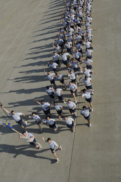 Member of the 8th Civil Engineer Squadron raise up their hands with a pitchfork symbol for their squadron mascot, the CE Red Devils, during a wing-wide Warrior Run on the flightline on Kunsan Air Base, Republic of Korea, May 4, 2012. Members of the 8th Fighter Wing kicked off their Post-CUI Block Party with an early morning run down the flightline celebrating the end of their four-week inspection by the Pacific Air Force Inspector General. (U.S. Air Force photo/Senior Airman Jessica Hines)