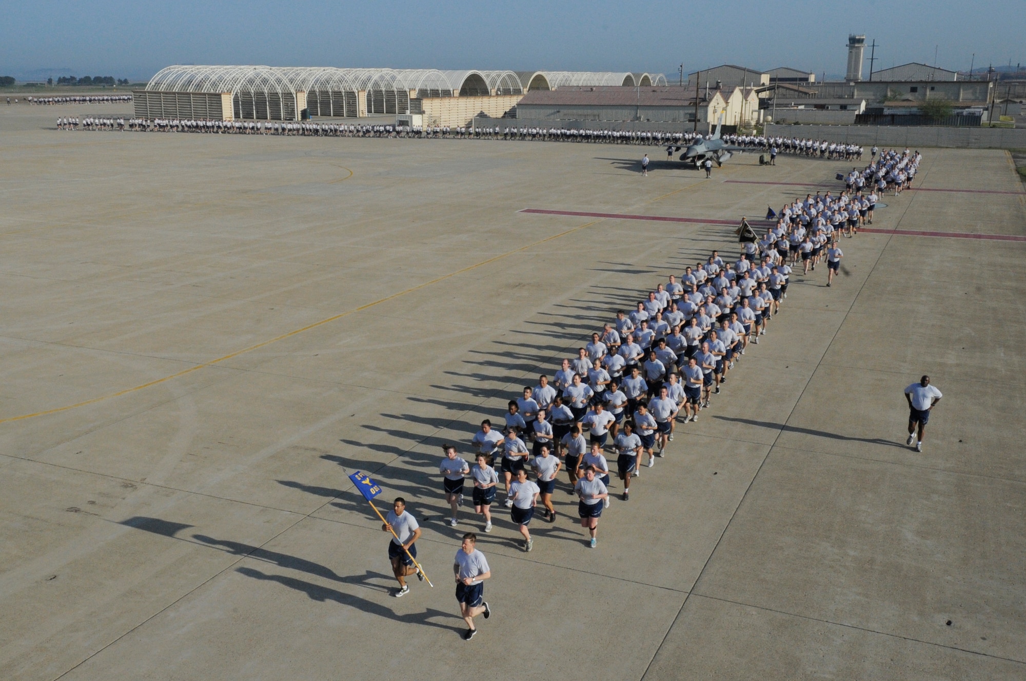 Wolf Pack Airmen run in formation during an early morning Warrior Run on the flightline on Kunsan Air Base, Republic of Korea, May 4, 2012. Members of the 8th Fighter Wing kicked off their Post-CUI Block Party with an early morning run down the flightline. (U.S. Air Force photo/Senior Airman Jessica Hines)