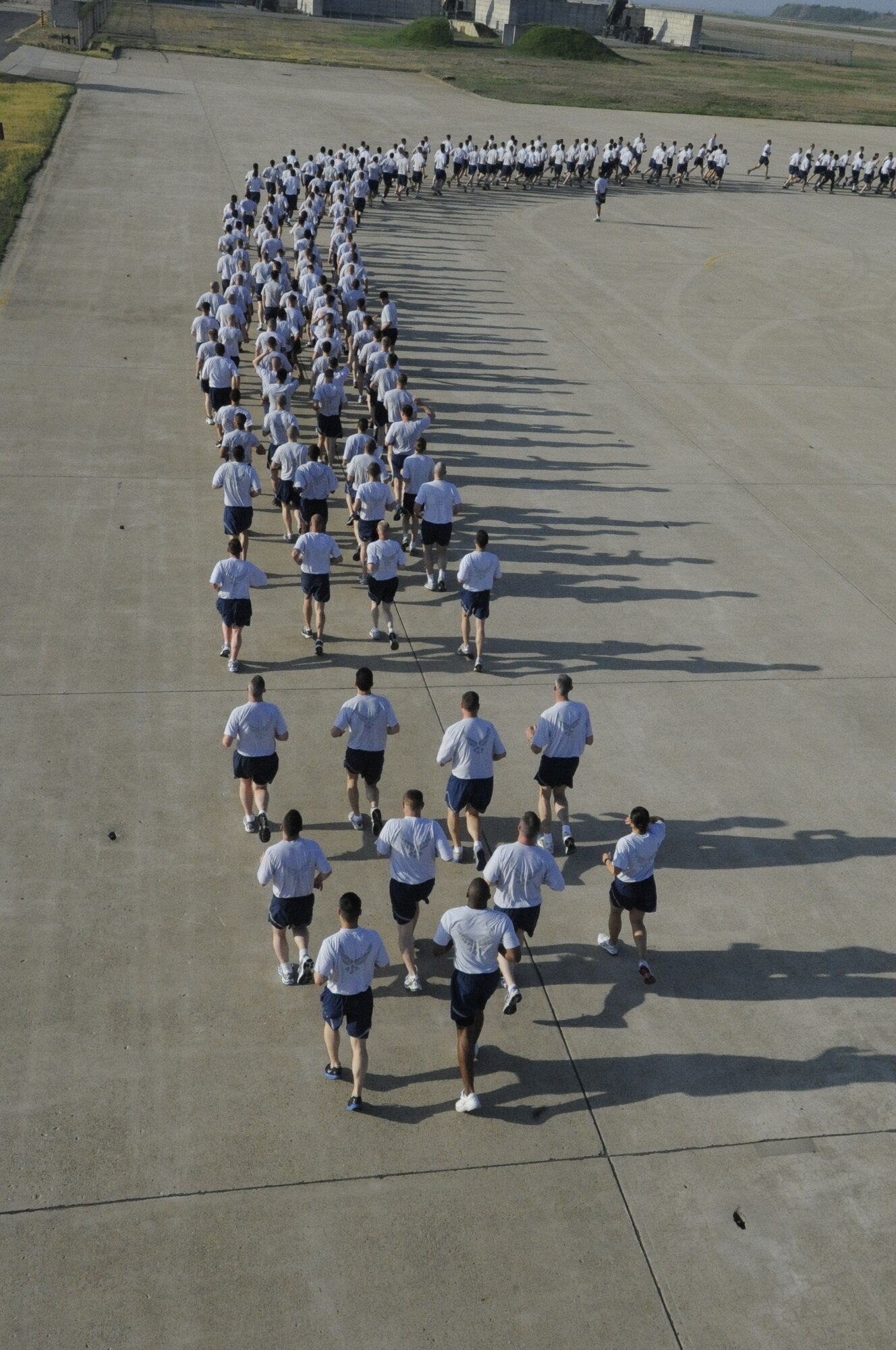 Wolf Pack Airmen run in formation during an early morning Warrior Run on Kunsan Air Base, Republic of Korea, May 4, 2012. Members of the 8th Fighter Wing kicked off their Post-CUI Block Party with an early morning run down the flightline. (U.S. Air Force photo/Senior Airman Jessica Hines)