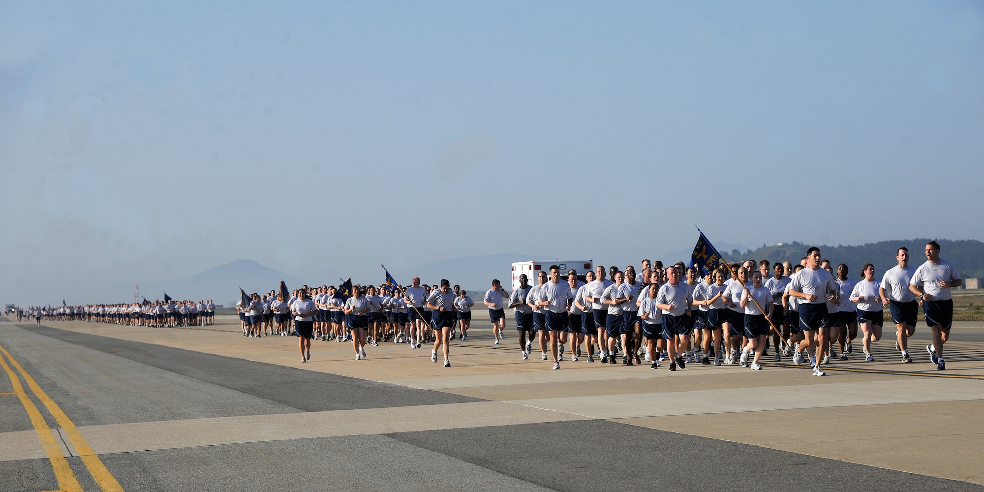 Wolf Pack Airmen run in formations during an early morning Warrior Run on Kunsan Air Base, Republic of Korea, May 4, 2012. Members of the 8th Fighter Wing kicked off their Post-CUI Block Party with an early morning 2.6-mile run down the flightline. (U.S. Air Force photo/Staff Sgt. Rasheen A. Douglas)