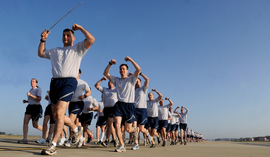 Wolf Pack Airmen run in formation during an early morning Warrior Run on Kunsan Air Base, Republic of Korea, May 4, 2012. Members of the 8th Fighter Wing kicked off their Post-CUI Block Party with an early morning run down the flightline. (U.S. Air Force photo/Staff Sgt. Rasheen A. Douglas)