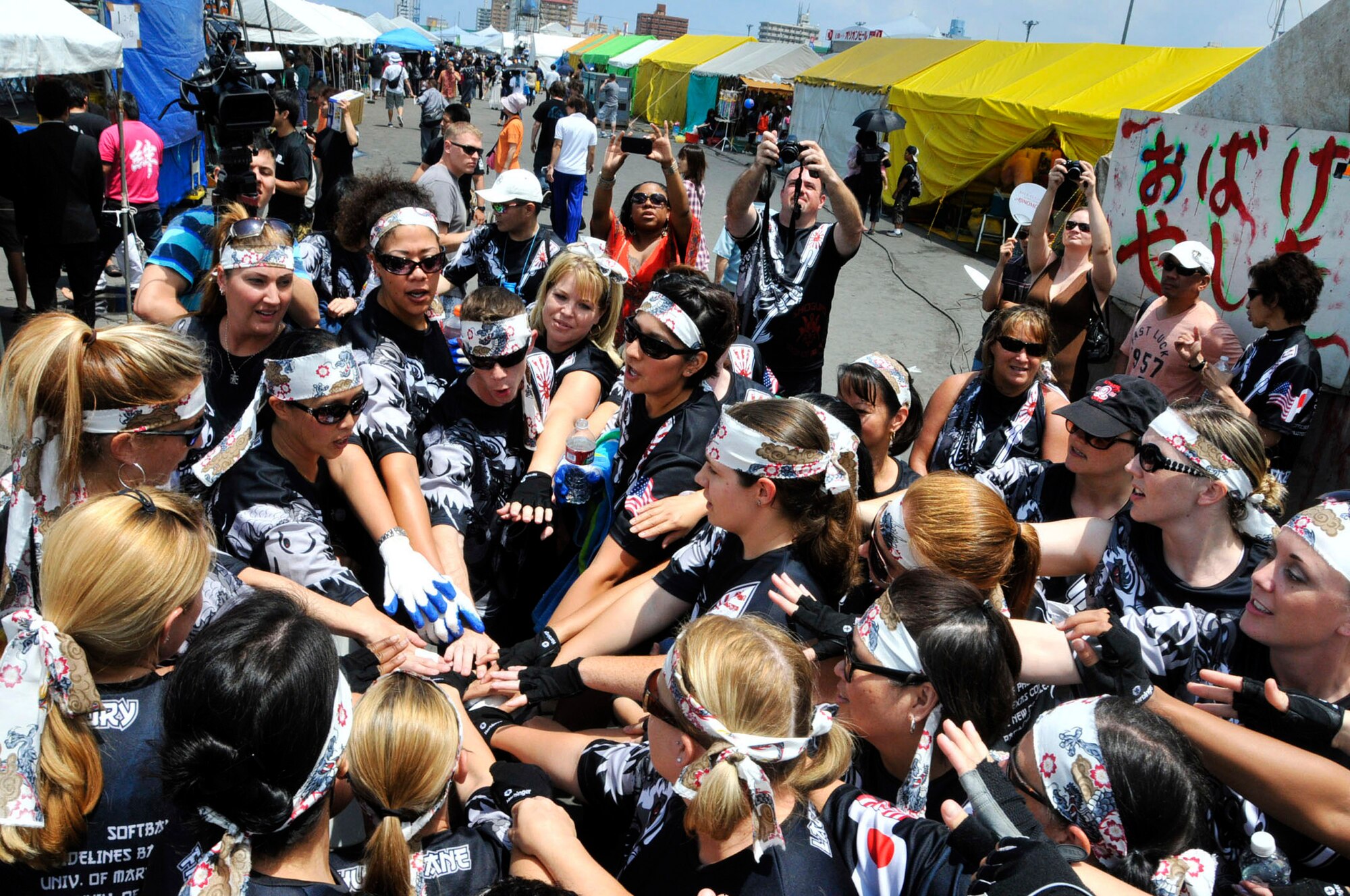 The Kadena Shogun women's team huddles up before the start of their race during the 38th Naha Dragon Boat Race at Naha City port, Okinawa, May 5. The women's team finished with a time of 5 minutes, 33 seconds, and came in third place in their heat. (U.S. Air Force photo/Staff Sgt. Darnell T. Cannady)  