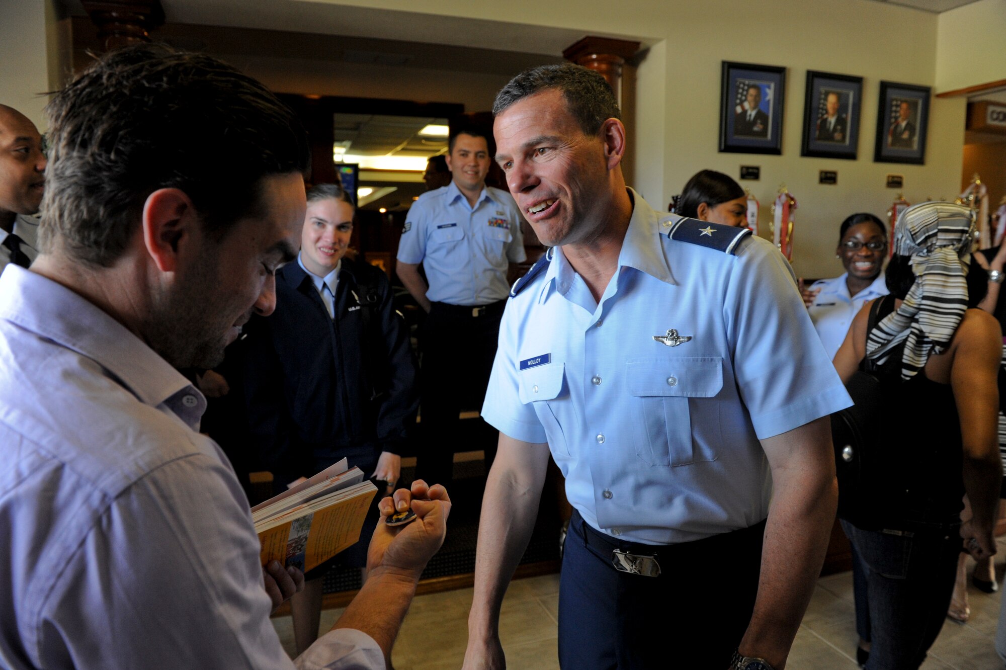U.S. Air Force Brig. Gen. Matthew Molloy, 18th Wing commander, coins actor Johnny Galecki, who currently stars on CBS’s “The Big Bang Theory” on Kadena Air Base, Japan, May 7, 2012. Galecki has also appeared in ABC’s “Roseanne” and the movie “I Know What You Did Last Summer”. (U.S. Air Force photo/Airman 1st Class Brooke P. Beers)