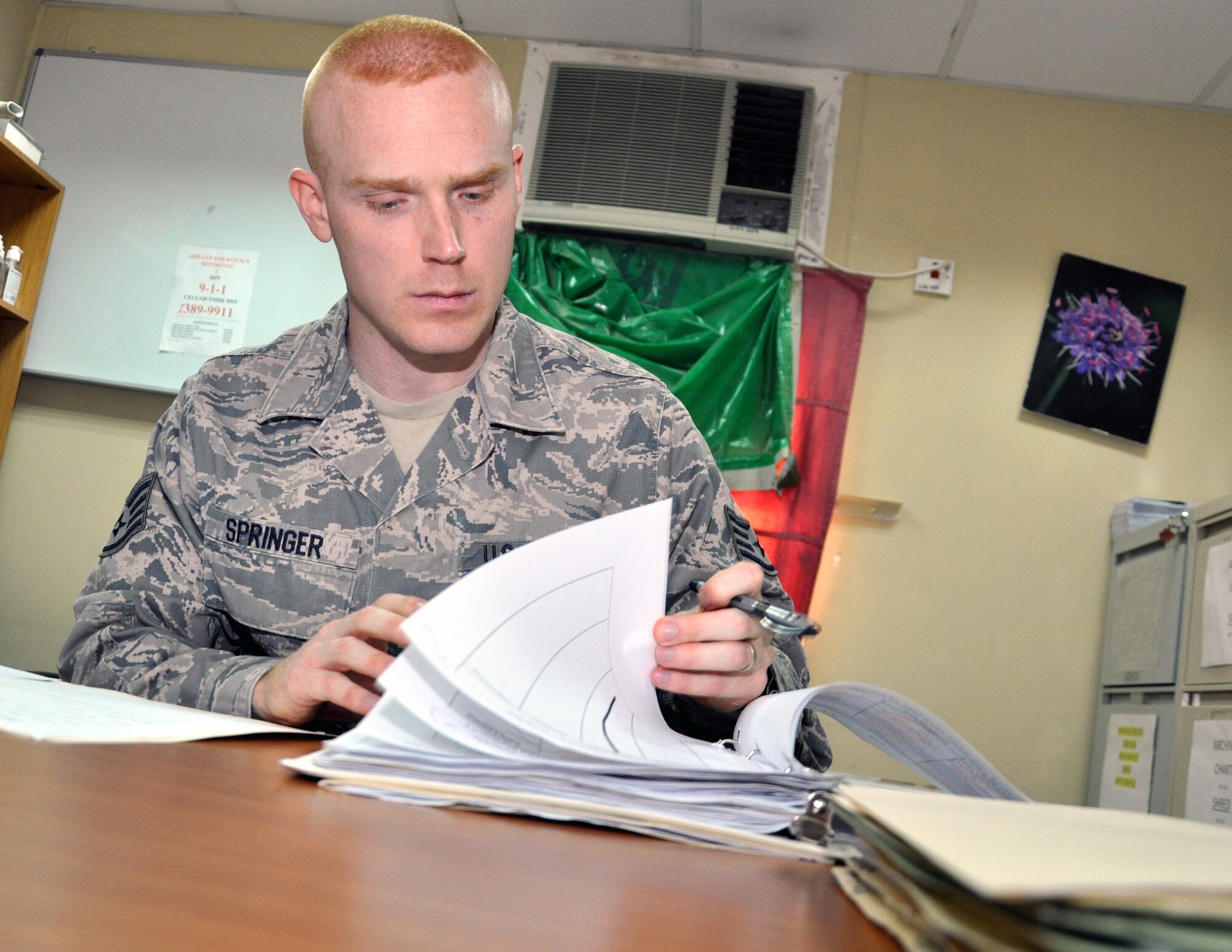 Staff Sgt. James Springer, a Joint Expeditionary Tasking Airman in the 387th Expeditionary Support Squadron, reviews patient records at the 325th Combat Support Hospital, Forward's Mental Health\Resiliency Clinic at an undisclosed location in Southwest Asia, May 3, 2012.  Springer, the clinic's NCO in charge, surpassed his fellow Army NCOs to win the 325th CSH (FWD) Soldier and NCO of the Quarter for the first quarter of 2012. Springer is a Leawood, Kas., native deployed from the 18th Medical Operations Squadron at Kadena Air Base, Japan. (U.S. Air Force photo/Tech. Sgt. Stacy Fowler)
