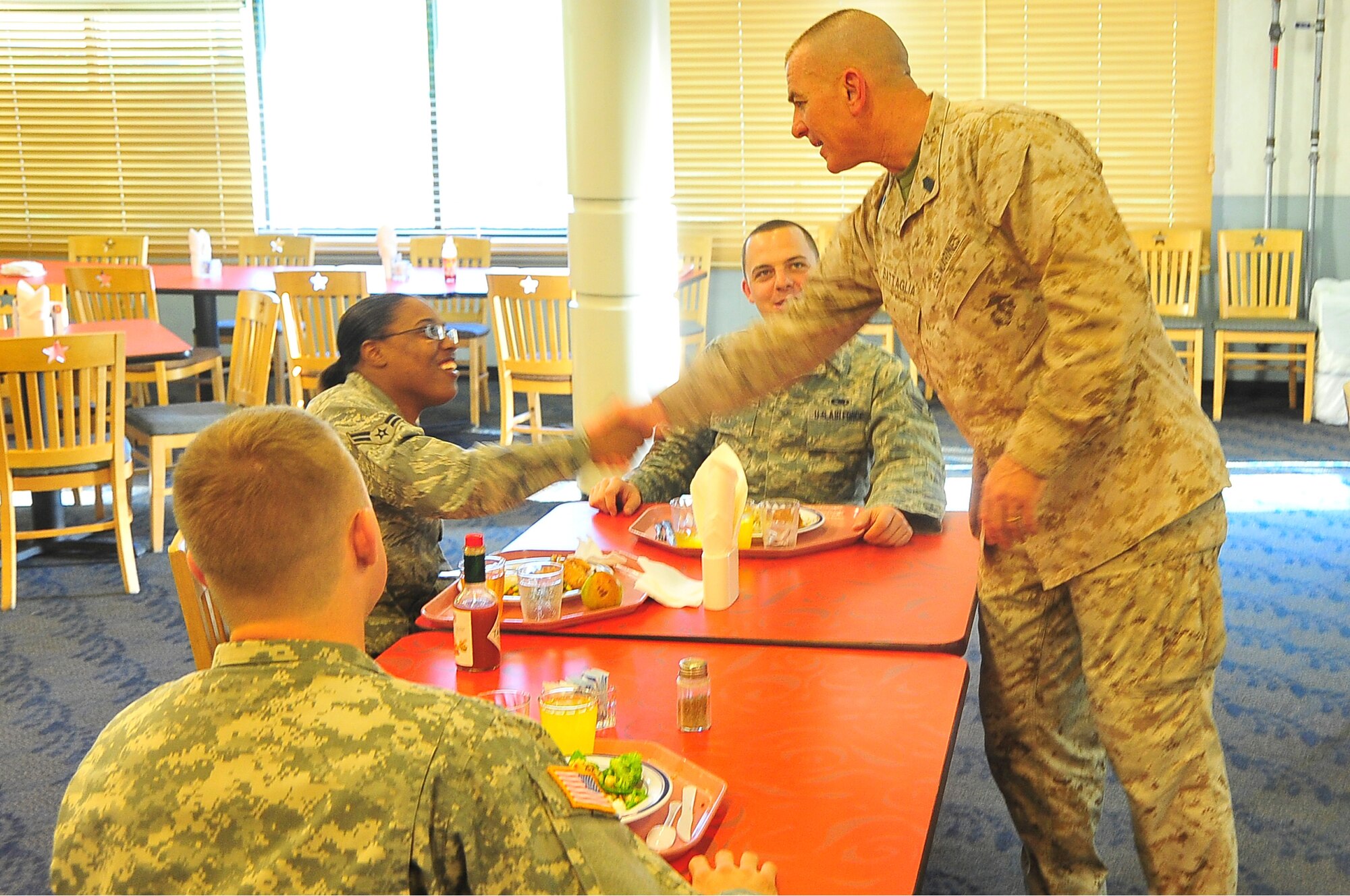 Marine Corps Sgt. Maj. Bryan Battaglia, Senior Enlisted Advisor to the Chairman of the Joint Chiefs of Staff, shakes the hands of Airmen during a dinner with the junior enlisted during a trip to Osan Air Base, Republic of Korea, May 3, 2012. Battaglia serves as the highest enlisted member in the U.S Armed Forces. He serves as the principal military advisor to the Chairman and the Secretary of Defense on all matters involving joint and combined total force integration, utilization, health of the force and joint development for enlisted personnel. (U.S. Air Force photo/Senior Airman Adam Grant)          