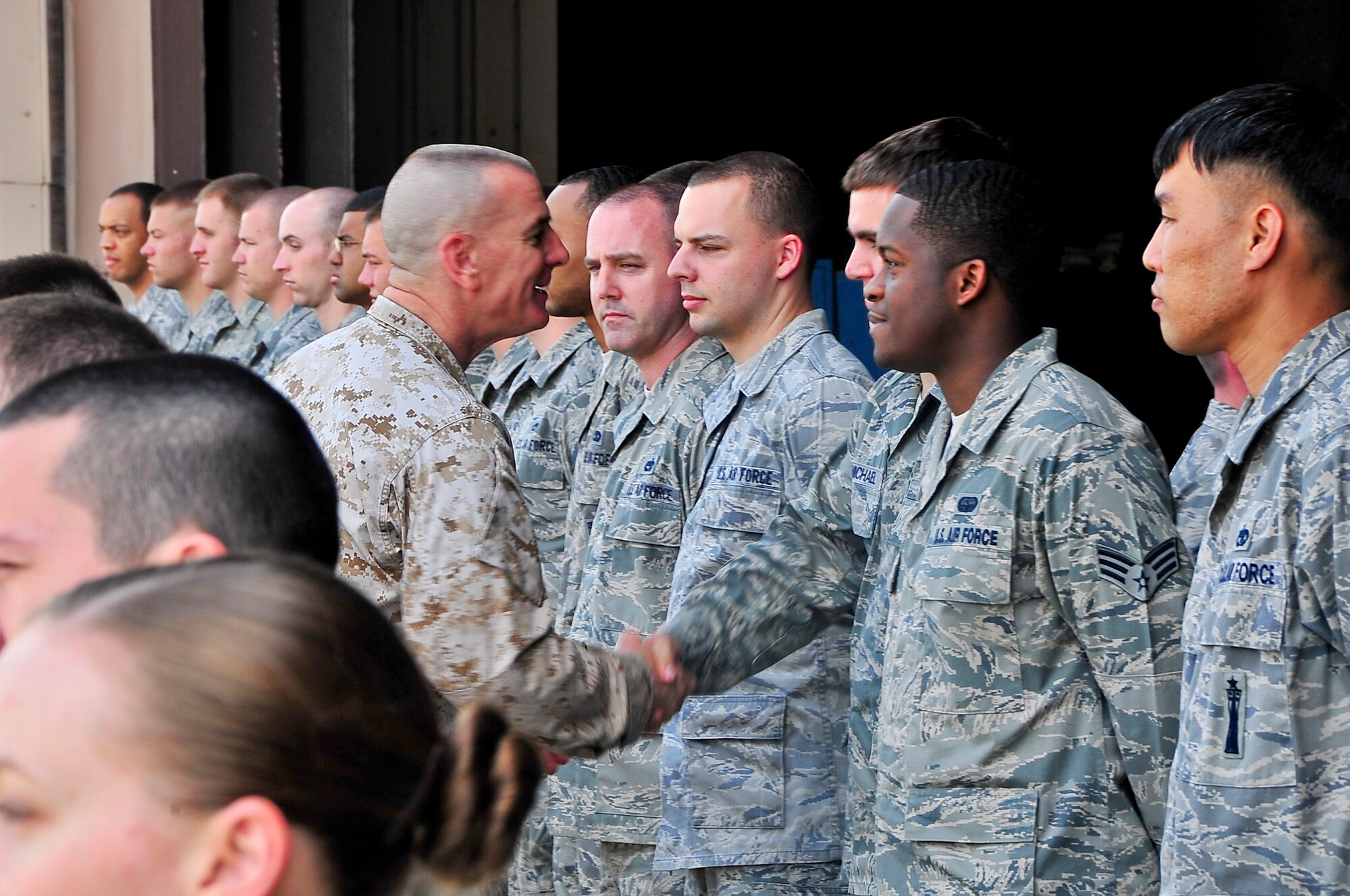Marine Corps Sgt. Maj. Bryan Battaglia, Senior Enlisted Advisor to the Chairman of the Joint Chiefs of Staff, shakes the hands of Airmen during a trip to Osan Air Base, Republic of Korea, May 3, 2012. During the visit, Battaglia toured multiple units around base, including the Air Traffic Control Tower, radar approach and control, 25th Fighter Squadron, flight simulators and the 607th Air Operation Center. (U.S. Air Force photo/Senior Airman Adam Grant)   