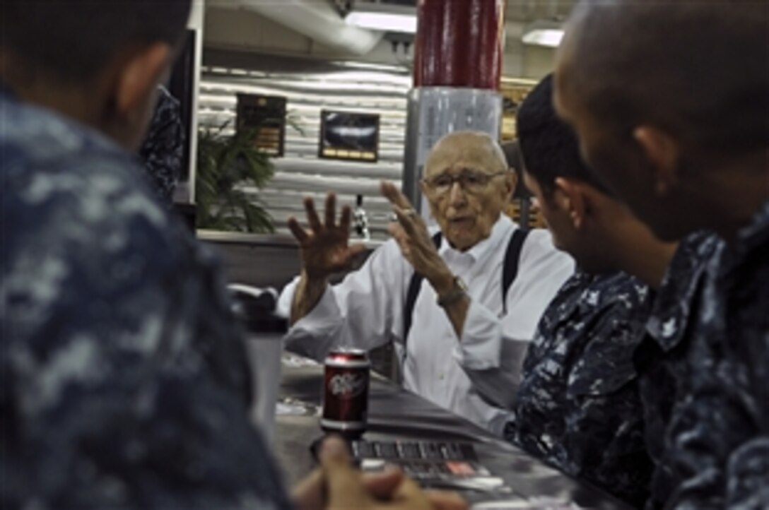 Harry Frey, a World War II veteran, discusses his time serving aboard the USS Lexington with sailors assigned to the USS Halsey in Brisbane, Australia, May 5, 2012. Frey survived a bombing aboard the Lexington during the Battle of Coral Sea. 