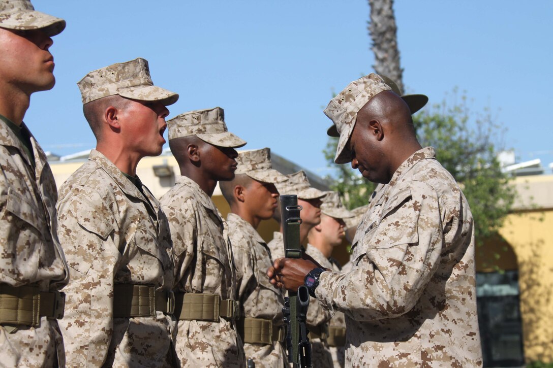 Capt. Lambrato Mathurin, follow series commander, Company B, 1st Recruit Training Battalion, inspects one of his recruits M-16 A4 service rifle April 9  during the Series Commander Inspection aboard Marine Corps Recruit Depot San Diego. Co. B recruits spent a week cleaning their weapons, preparing their desert combat utility uniforms and reviewing Marine Corps knowledge they had learned so far at recruit training.