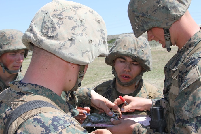Recruits of Platoon 2135, Company F, 2nd Recruit Training Battalion, use a compass as a straightedge in order to find their destination at the land navigation event on the Crucible aboard Edson Range, Marine Corps Base Camp Pendleton April 10. During the land navigation event the recruits are put in teams of five with a compass, map, protractor and pen, and have to find a specific location.