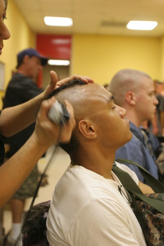 A recruit receives his first military haircut during receiving April 23 aboard Marine Corps Recruit Depot San Diego. Every recruit's head is shaved bald to elaborate the fact that there are no individuals in recruit training.