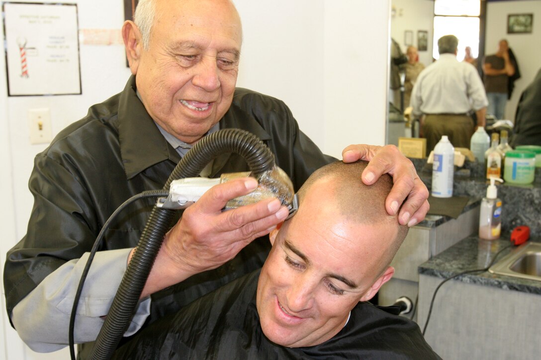 Leonardo Herrera, recruit barber, gives his last hair cut to 1st Sgt. Sean P. Farrow, Company 1st Sgt., Company B, 1st Recruit Training Battalion, at the recruit barbershop April 27 aboard Marine Corps Recruit Depot San Diego. Herrera, an 81-year-old Tecuala, Nayarit, Mexico native, is retiring after 42 years of cutting hair for recruits and Marines. "He cut my hair when I was a recruit here," said Farrow, who went through recruit training 18 years ago. "He still looks the same." Herrera started cutting hair in 1969 at MCRD. "I have cut hair for everybody, from recruits to Sergeant's Major," said Herrera. "I feel sad, but I have many good memories and I've enjoyed every moment of my time here." 