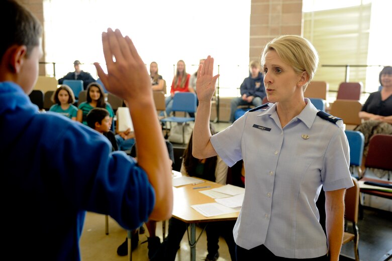 VANDENBERG AIR FORCE BASE, Calif.--  Capt. Aimee Haney, 30th Space Wing assistant judge advocate, swears in a 'witness' during a mock trial with students at Vandenberg Middle School here Monday, May 7th, 2012. The Judge Advocate office worked with VMS students to hold a mock trial to help them better understand the American justice system. (U.S. Air Force photo/Staff Sgt. Levi Riendeau)