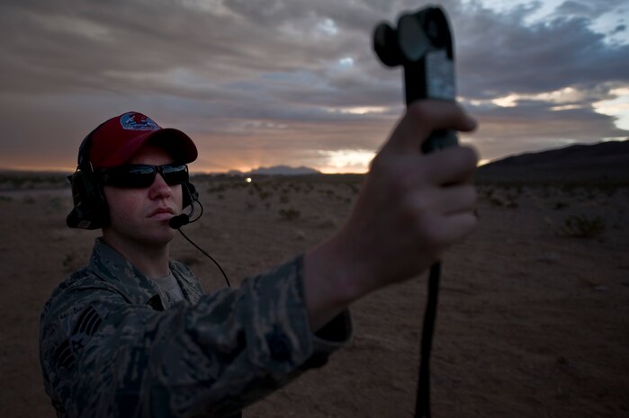 U.S. Air Force Staff Sgt. Sean McCarty, 820th RED HORSE Squadron airborne flight member, uses an anemometer to measure wind speed  during a training mission, April 26, 2012, at Nellis Air Force Base, Nev. Anemometers are instrumental in the safety for the members jumping. (U.S. Air Force photo by Airman 1st Class Daniel Hughes)