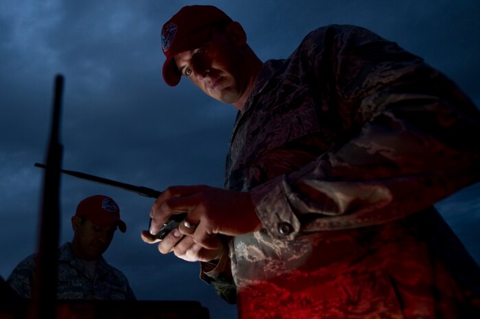 U.S. Air Force Tech. Sgt. Kellen Buss, 820th RED HORSE Squadron airborne flight member,  turns on phantom lights to light the designated landing zone during a training mission, April 26, 2012, at Nellis Air Force Base, Nev. Lighting a DLZ during a low-light jump allows pilots and jumpers to see the target. (U.S. Air Force photo by Airman 1st Class Daniel Hughes)