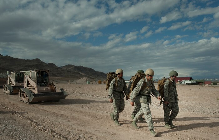 Airmen from the 820th RED HORSE Squadron airborne flight move equipment to a training site to fix a simulated runway during a training mission April 26, 2012, at Nellis Air Force Base, Nev. RED HORSE Combat Engineer Flights provide special capabilities to conduct expedient repairs to airfield surfaces and evaluate supporting infrastructure for potential follow-on forces. (U.S. Air Force photo by Staff Sgt. Christopher Hubenthal)