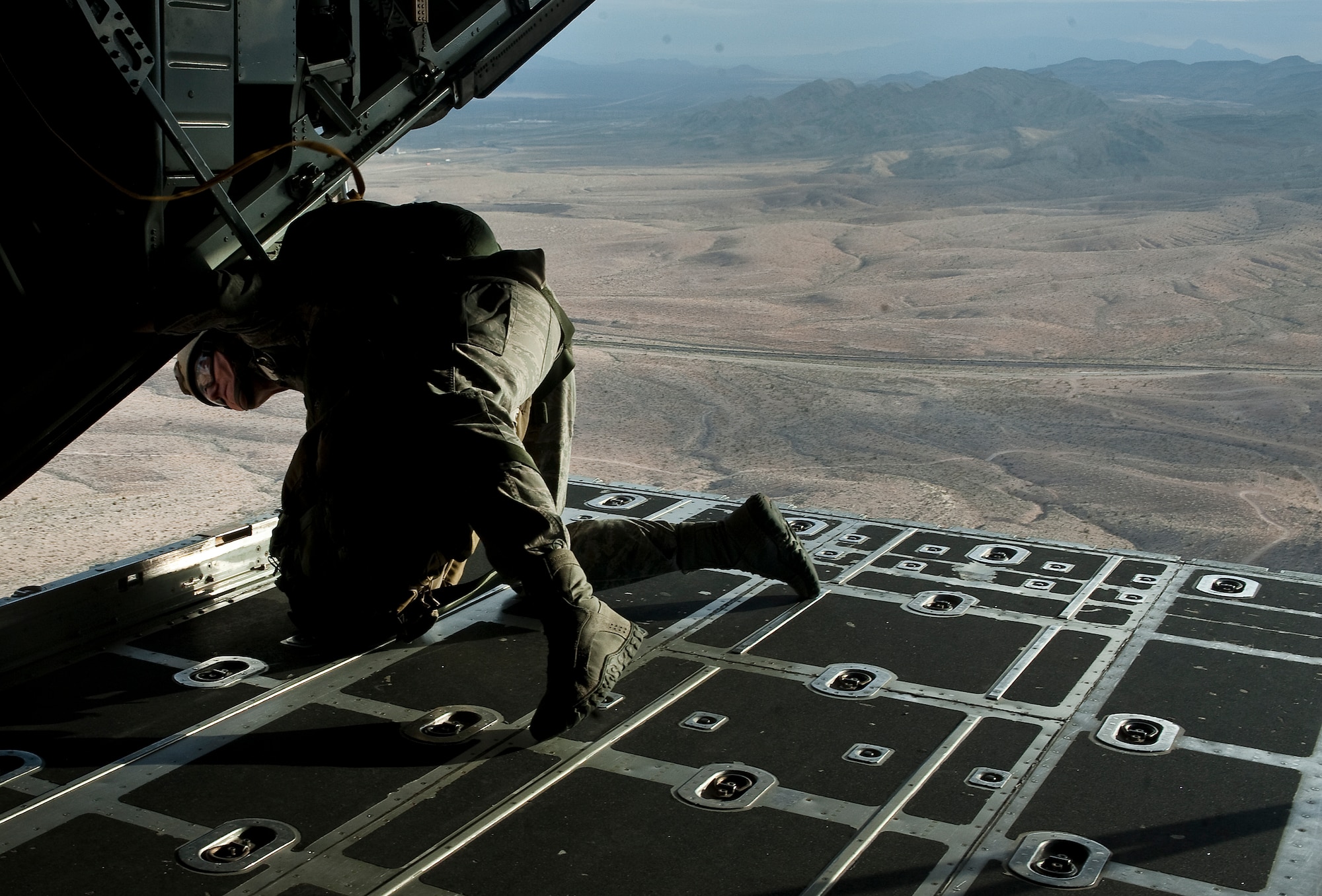 U.S. Air Force Tech. Sgt. Mitch Romag 820th RED HORSE Squadron airborne flight jump master ensures it is safe to conduct a static line jump from a Wyoming Air National Guard C-130 Hercules during a training mission April 24, 2012, at Nellis Air Force Base, Nev. Airmen of the 820th RED HORSE Squadron must maintain a high state of readiness through an aggressive training regimen. (U.S. Air Force photo by Staff Sgt. Christopher Hubenthal)