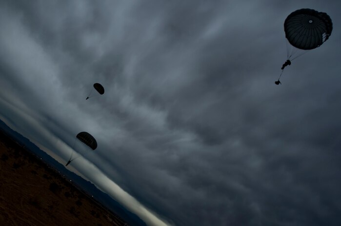 Airmen parachute during a training mission, April 25, 2012, at Nellis Air Force Base, Nev. Members of RED HORSE and Joint Terminal Attack Controllers took part in refresher and qualification jumps. (U.S. Air Force photo by Airman 1st Class Daniel Hughes)