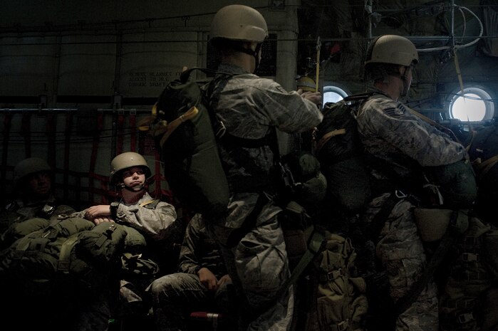 U.S. Air Force Master Sgt. James Ward, 820th RED HORSE Squadron airborne flight airborne engineering assistant, watches as Airmen from the prepare to conduct a static line jump from a Wyoming Air National Guard C-130 Hercules, during a training mission April 24, 2012, at Nellis Air Force Base, Nev. The training allowed 820th RED HORSE Squadron Airmen to remain qualified. (U.S. Air Force photo by Staff Sgt. Christopher Hubenthal)