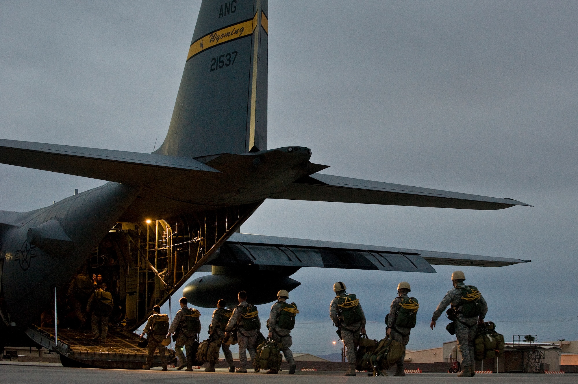 U.S. Air Force Airmen, 820th RED HORSE Squadron airborne flight, board a Wyoming Air National Guard C-130 Hercules, during a training mission April 24, 2012, at Nellis Air Force Base, Nev. The 820th RED HORSE Squadron provides rapidly deployable engineering support in volatile, uncertain, complex and ambiguous environments. (U.S. Air Force photo by Staff Sgt. Christopher Hubenthal)
