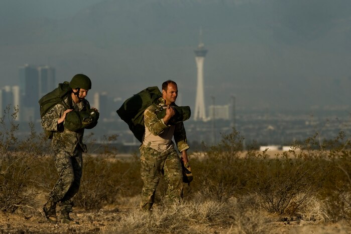 U.S. Air Force Master Sgt. Eric Muller, 6th Combat Training Squadron joint terminal attack controller instructor, and U.S. Air Force Staff Sgt. Ian Zerby, 820th RED HORSE Squadron airborne flight member, ruck back to the designated landing zone during a training mission, April 24, 2012, at Nellis Air Force Base, Nev. RED HORSE airmen perform airdrop missions to stay current on training and certifications, which enables them to perform jump missions and operate their own drop zones. (U.S. Air Force photo by Airman 1st Class Daniel Hughes)