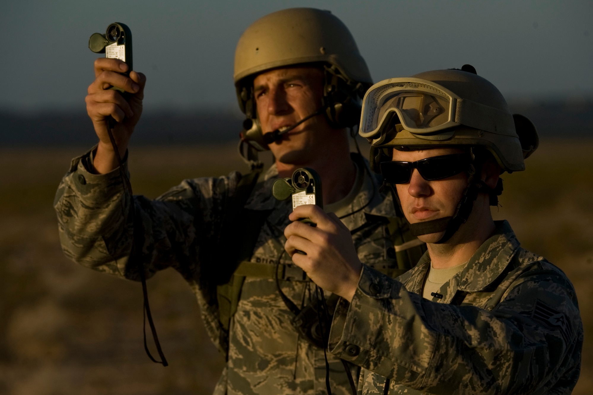 U.S. Air Force Staff Sgt. Sean McCarty, 820th RED HORSE Squadron airborne, and Tech. Sgt. Kellen Buss, use anemometers to measure wind speed during a training mission, April 24, 2012, at Nellis Air Force Base, Nev. RED HORSE can rapidly deliver small specialized teams and equipment packages by airdrop or air insertion to conduct expedient airfield repairs. (U.S. Air Force photo by Airman 1st Class Daniel Hughes)
