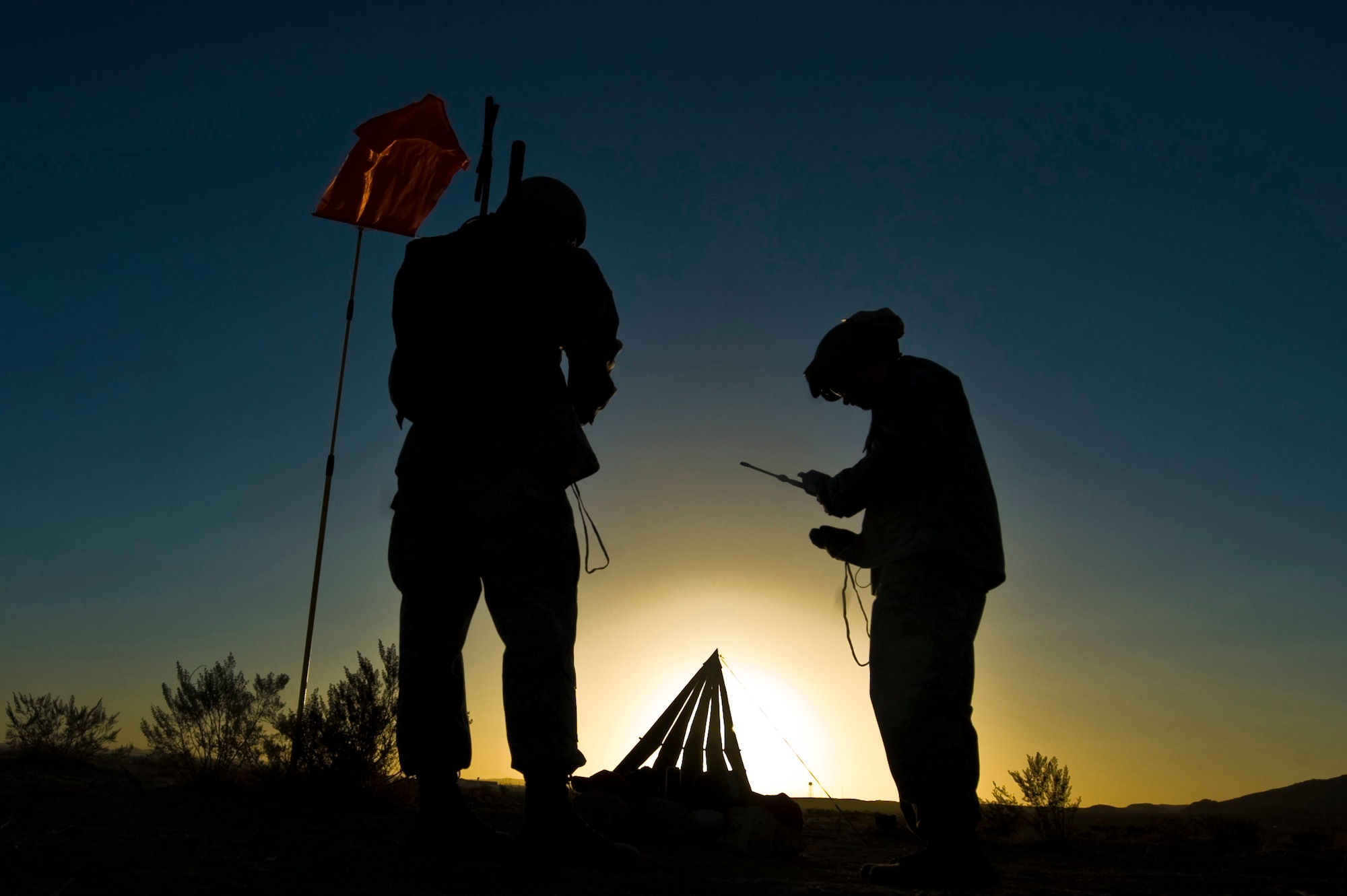 U.S. Air Force Staff Sgt. Sean McCarty, 820th RED HORSE Squadron airborne flight firefighter, and Tech. Sgt. Kellen Buss, water and fuels systems maintenance craftsman, check radio frequencies during a training mission, April 24, 2012, at Nellis Air Force Base, Nev. RED HORSE added an airborne capability in 2005. (U.S. Air Force photo by Airman 1st Class Daniel Hughes)
