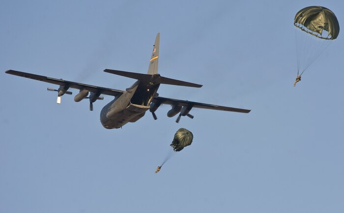 Airmen from the 820th RED HORSE Squadron?s airborne flight drop from a C-130 Hercules flown by the Wyoming Air National Guard during a training mission April 24, 2012, at Nellis Air Force Base, Nev. The static-line jump mission included Airmen from the 820th RHS, 6th Combat Training Squadron and the 58th Rescue Squadron. (U.S. Air Force photo by Staff Sgt. Christopher Hubenthal)