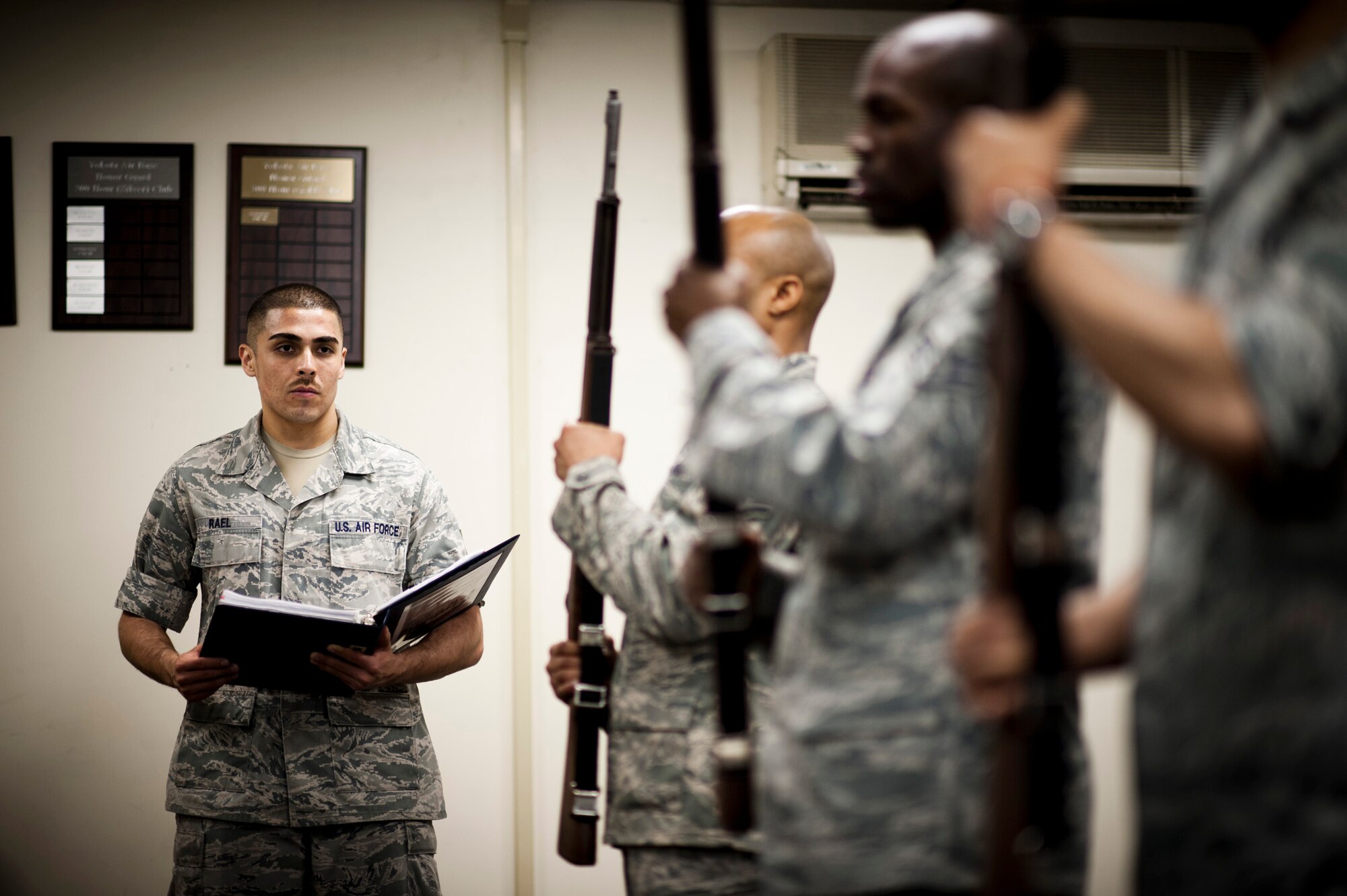 YOKOTA AIR BASE, Japan -- Staff Sgt. Tyrone Rael, Yokota Honor Guard NCO in charge, watches new recruits as they perform rifle movements during a week-long training program at Yokota Air Base, Japan, May 1, 2012. (U.S. Air Force photo by Staff Sgt. Samuel Morse)