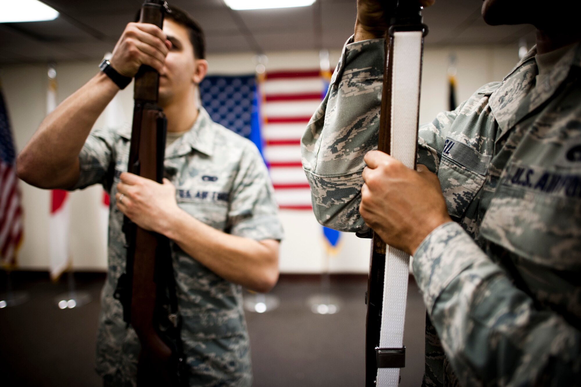 YOKOTA AIR BASE, Japan -- Senior Airman Gabriel Gill, right, Yokota Honor Guardsman, teaches Airman 1st Class Simon Tarango, honor guard recruit, how to handle a rifle at Yokota Air Base, Japan, May 1, 2012. Upon successful completion of training, Tarango was selected for the base honor guard team.  (U.S. Air Force photo by Staff Sgt. Samuel Morse)