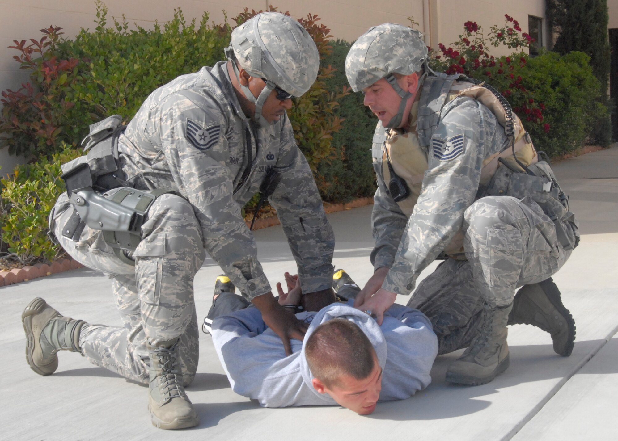 95th Security Forces Squadron personnel apprehend a "suspect" after responding to an active shooter scenario during the USNORTHCOM directed exercise, Ardent Sentry 2012. The week-long exercise began May 2 and tested Team Edwards' response to numerous incidents. (Air Force Photo by Laura Mowry)