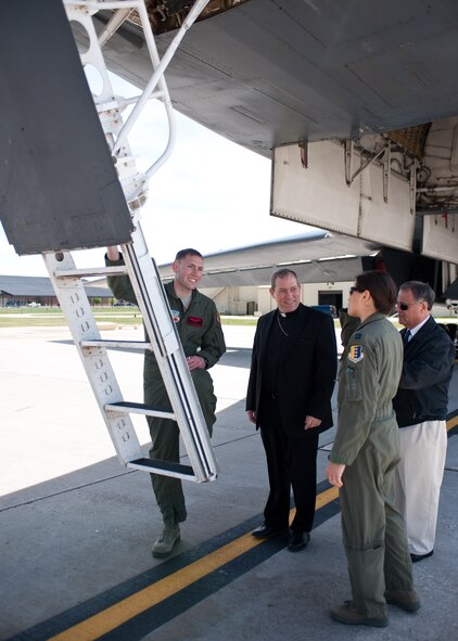 Capt. Curtis Michael, 34th Bomb Squadron pilot (left), and Capt. Miranda Brasko, 34th BS weapon systems operator,  provide Bishop Robert Gruss, Bishop of the Diocese of Rapid City, and Deacon Raul Daniels, 28th Bomb Wing Catholic community coordinator/pastoral associate, a tour inside the cockpit of a B-1 bomber during the bishop’s tour of Ellsworth Air Force Base, S.D., May 2, 2012. The Bishop visited Ellsworth to become familiar with the base and to better understand the mission and challenges of Ellsworth Airmen. (U.S. Air Force photo by Airman 1st Class Alystria Maurer/Released)