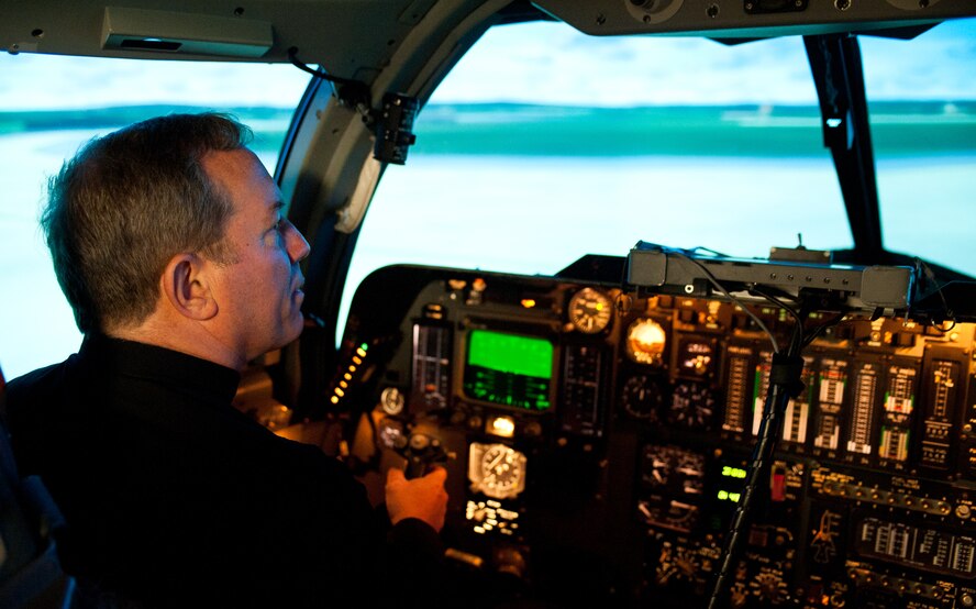 Robert Gruss, Bishop of the Diocese of Rapid City, takes control of a B-1 bomber simulator during his tour of Ellsworth Air Force Base, S.D., May 2, 2012. The bishop visited a variety of facilities on Ellsworth, experienced the thrill of flying theB-1 in the simulator, received an up-close look of an actual B-1, and met with Col. Weatherington, 28th Bomb Wing commander, and other base leaders during his visit. (U.S. Air Force photo by Airman 1st Class Alystria Maurer/Released)